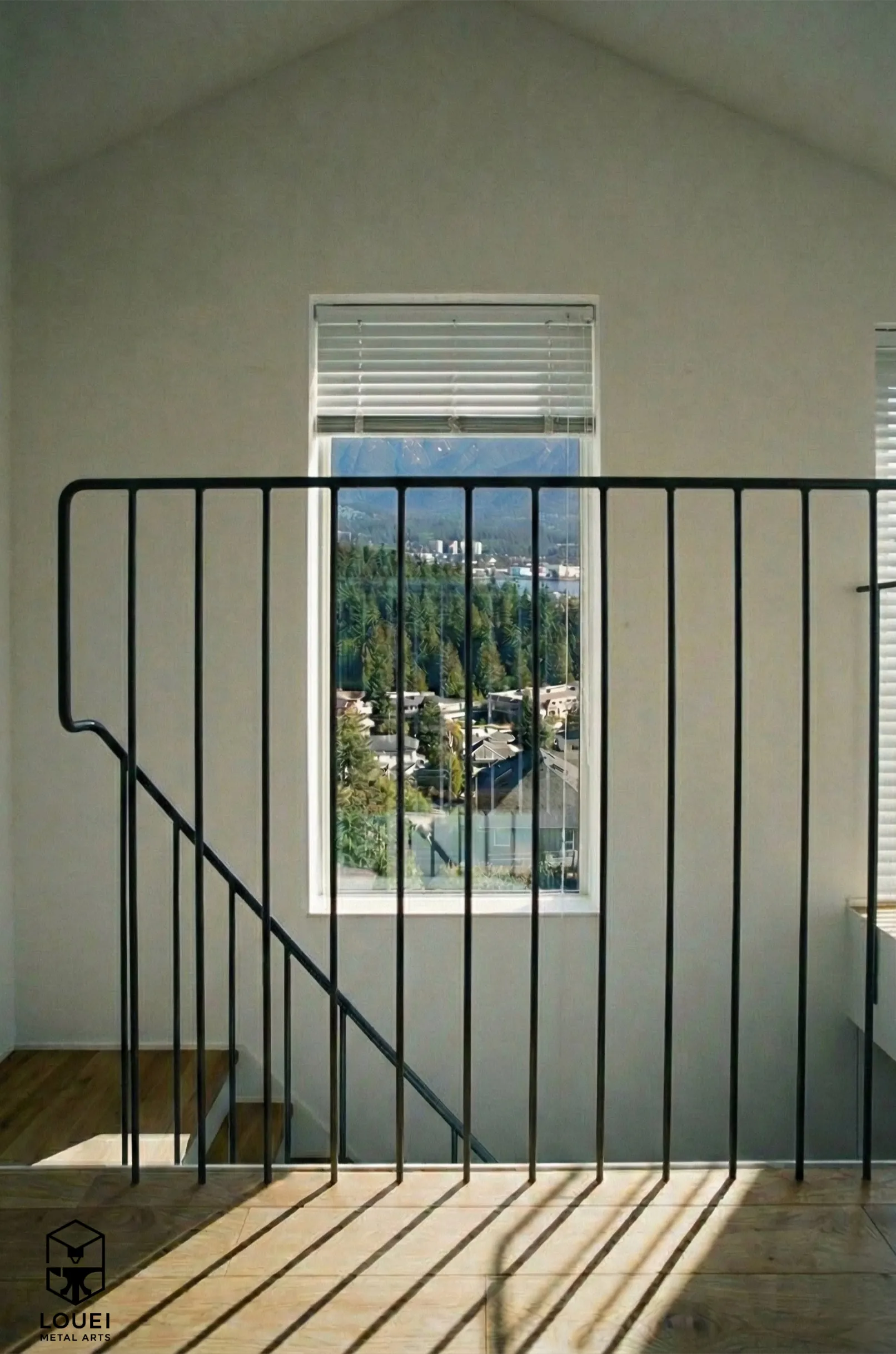 Slim black picket loft guard railing with North Vancouver mountain views