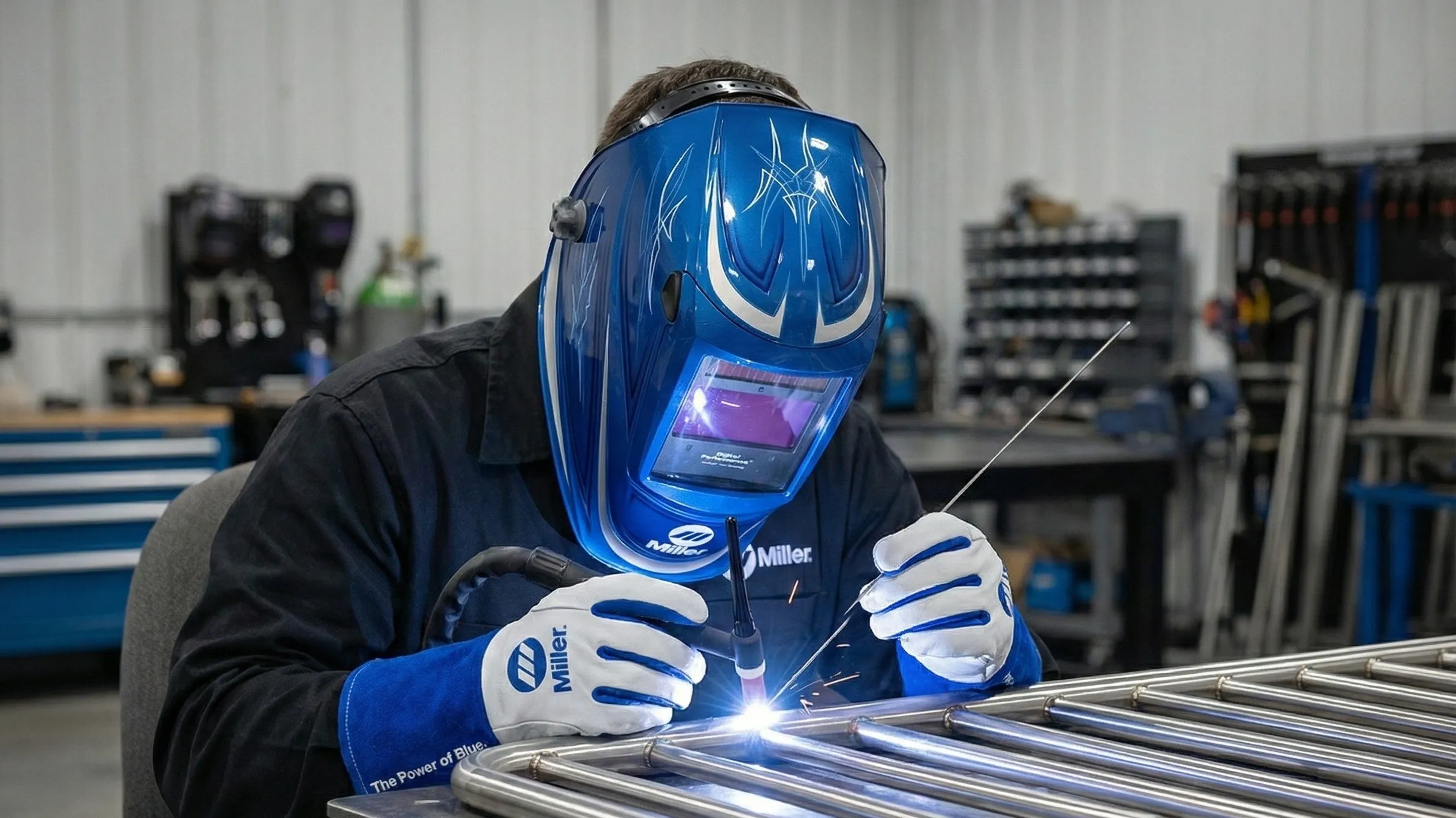 Welder working on a custom steel railing frame in the LOUEI Metal Arts shop in Coquitlam.