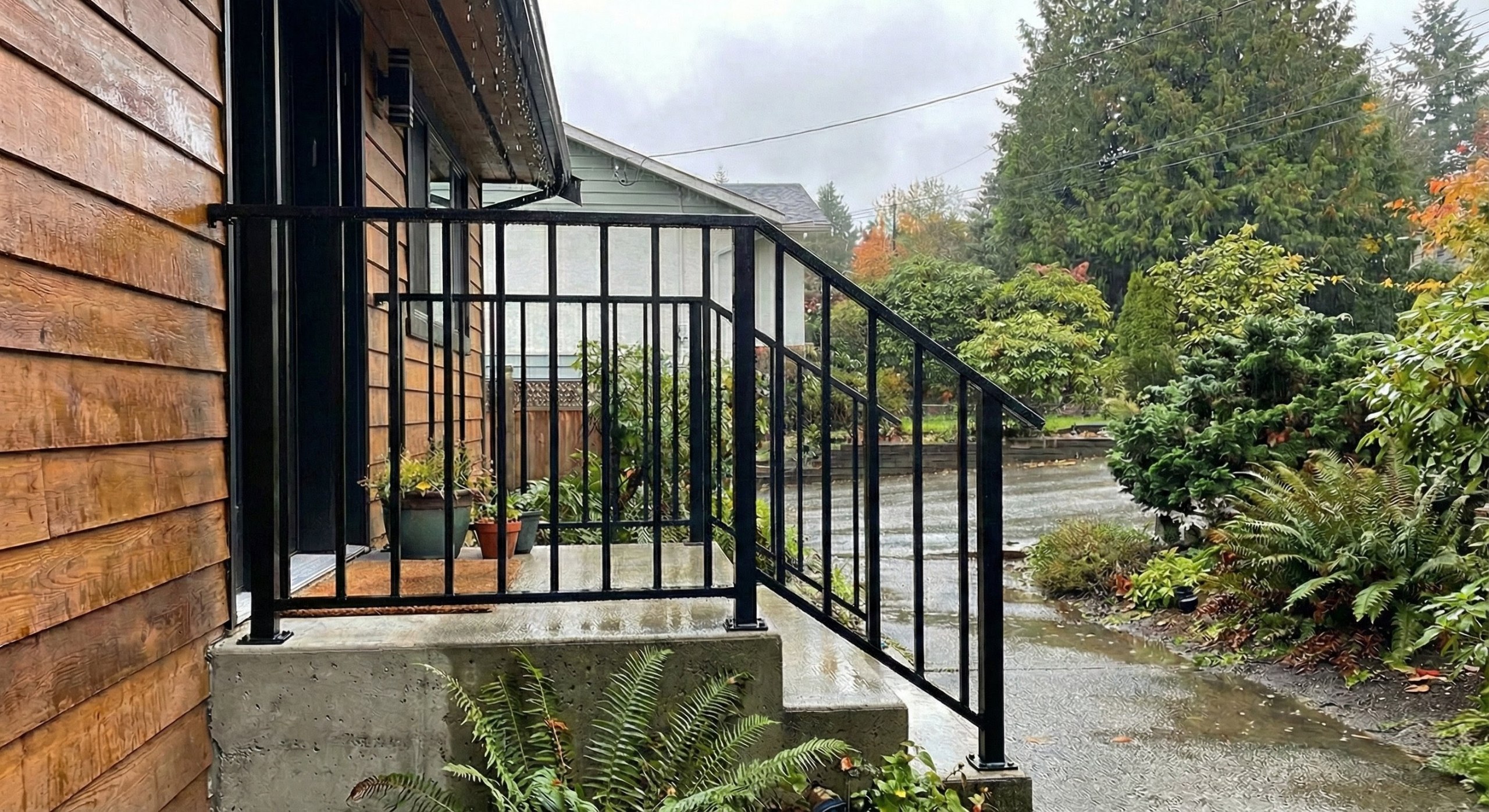 Coquitlam exterior stair picket railing with black finish