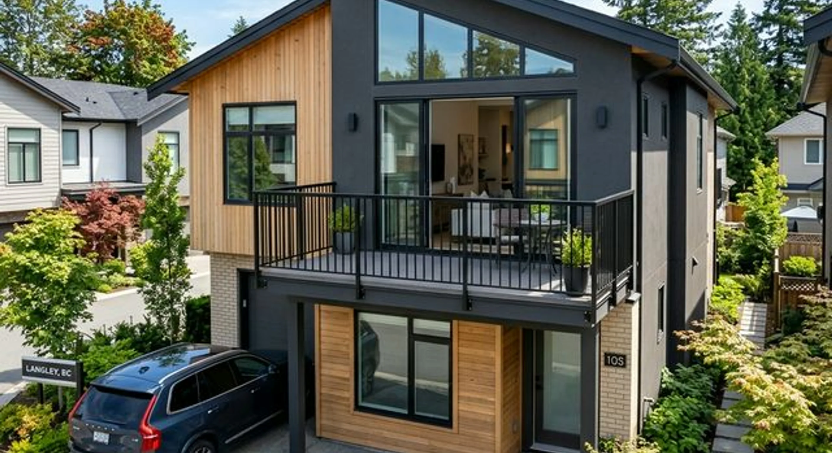 Builder-grade aluminum railing being replaced with custom powder-coated steel on a Willoughby Heights townhome deck in Langley, BC